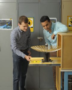 RainCube’s radiofrequency lead Nacer Chahat (right) and mechanical engineer lead Jonathan Sauder (left) observe the CubeSat’s deployed antenna. (Credit: NASA/JPL-Caltech)